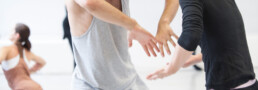 Two dancers communicate with their hands